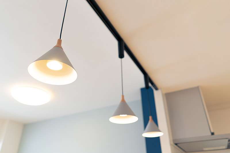 3 pendant lights hanging down with a ceiling light in the room behind them