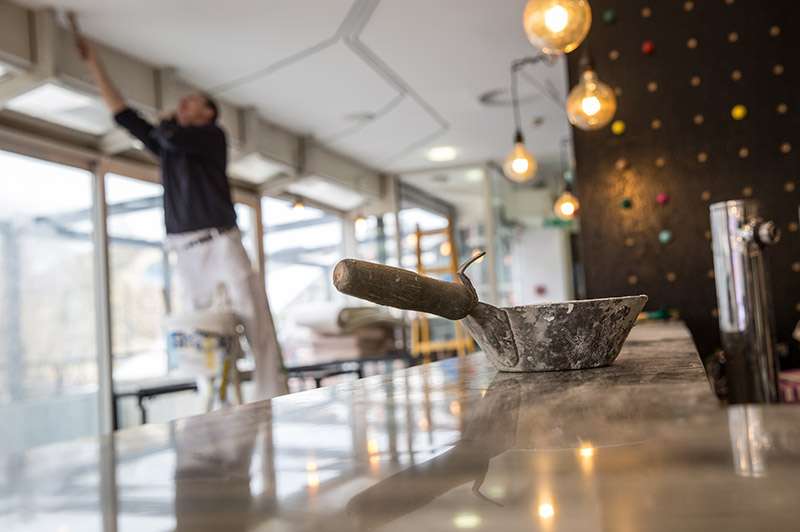 Man working towards energy efficient lighting design for his new business