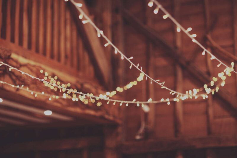 fairy lights hanging in an old beautiful barn wedding details