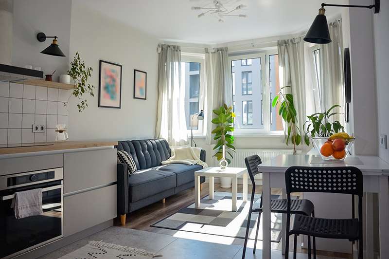 Smaller room utilising layered lighting and natural light to brighten the space